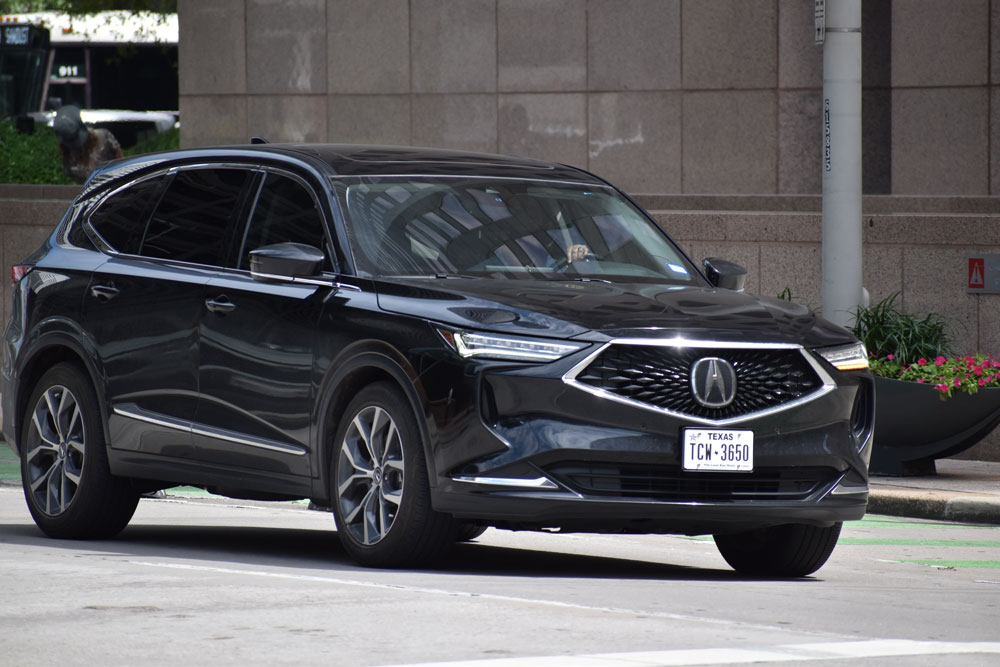 A black Acura being driven