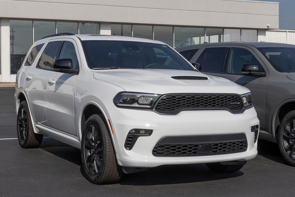 A white Dodge in an auto dealer parking lot